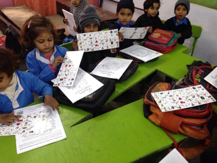 Children learning with Phonics Club pilot project materials